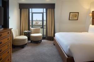 a hotel room with a bed and a window at Radisson Blu Hotel, London Leicester Square in London +114 photos