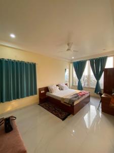a bedroom with a bed and a large window at Staeg Dharashray Farm in Indore