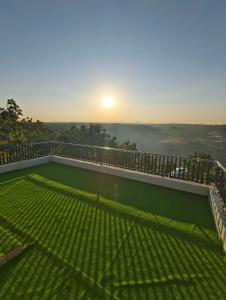 a view of the sunrise from the balcony of a house at Staeg Dharashray Farm in Indore