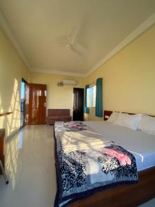 a bedroom with a bed with a blanket on it at Staeg Dharashray Farm in Indore +6 photos