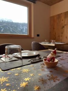 a table with a bowl of ice cream on a table at Gran Zebrú B&B - high mountain in Valfurva +65 photos