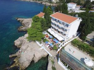 an aerial view of a hotel on a rocky island in the water at Apartments & Rooms Elite in Dobra Voda