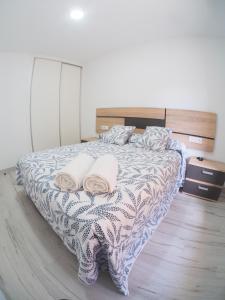 a bedroom with a bed with two pillows on it at El Origen in Carboneras de Guadazaón