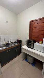 a kitchen with a sink and a counter with a microwave at BLEND Work in Nova Hartz