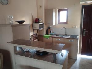 a small kitchen with a counter and a sink at Sea view in Sozopol