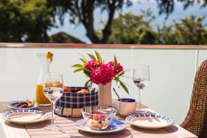 a table with food and wine glasses and flowers at Ostseeblick Sassnitz in Sassnitz