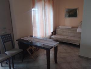 a living room with a table and a couch at Sea view in Sozopol