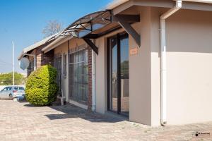 a building with awning on the side of it at Emmanuel Guesthouse in eMalahleni