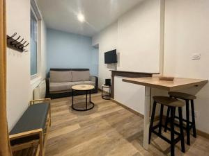 a living room with a couch and a table at appartement t2 la doutre 2-4 personnes in Angers