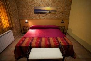 a bedroom with a bed and two chairs in it at Casa Llebra I in Tortosa