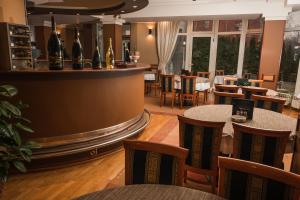 a restaurant with tables and chairs and a bar at Hotel Terex in Sarajevo