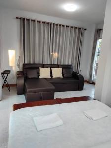a living room with two beds and a couch at Huan Janto Homestay - Nimmanaradee in Ban Sam Lang
