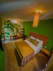 a bedroom with a large bed with a green wall at Villa Jaguar Fortim in Fortim +127 photos