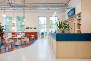 um saguão de um escritório com mesas e cadeiras em aparto Milan Ripamonti em Milão mais 27 fotografias