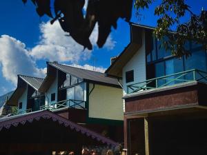 a building with a bird sitting on top of it at Meraki Cottage in Darjeeling