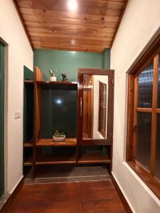 een kamer met houten planken en een raam bij Meraki Cottage in Darjeeling