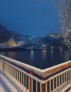 a view of a river with a white fence at Old Town Maglaj in Maglaj +7 photos