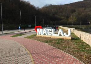 a sign for a macau sign on the side of a road at Old Town Maglaj in Maglaj