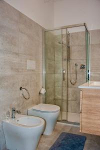 a bathroom with a toilet and a shower and a sink at Paradise B&B in Panicarola +23 photos
