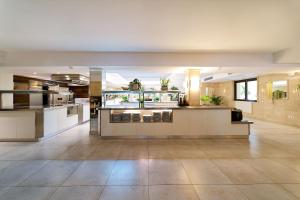 a large room with a kitchen and a lobby at R2 Lago Playa Park in Cala Ratjada