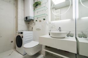a white bathroom with a toilet and a sink at The View - Apartment with Pool in Blizikuće