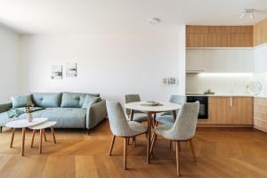 a living room with a couch and a table and chairs at The View - Apartment with Pool in Blizikuće