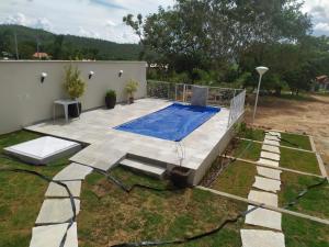 ein Schwimmbad in einem Hof neben einem Haus in der Unterkunft Quintal dos Pinheiros in Pirenópolis