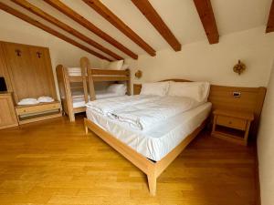 a bedroom with a bed and two bunk beds at HC Hotel Garni - Rooms and Apartments in Cembra +16 photos
