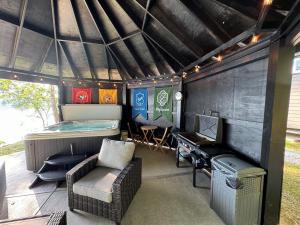 a small house with a bed and a desk and a piano at Hagrid's Hut - Harry Potter Riverfront Experience in New Richmond