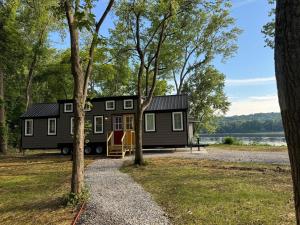 a tiny house on the side of a lake at Hagrid's Hut - Harry Potter Riverfront Experience in New Richmond
