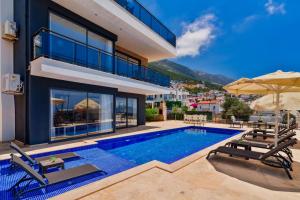 een villa met een zwembad en tuinmeubilair bij Villa Vala in Kalkan