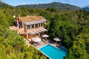 an aerial view of a house with a swimming pool at Villa Elea Corfu by Villa Plus in Paleokastritsa