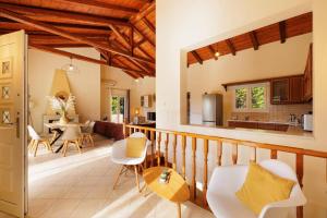 a living room and kitchen with wooden ceilings at Villa Elea Corfu by Villa Plus in Paleokastritsa