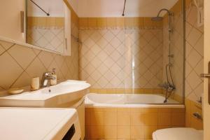 a bathroom with a sink and a shower and a toilet at Villa Elea Corfu by Villa Plus in Paleokastritsa +16 photos