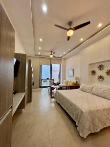 a bedroom with a bed with a ceiling fan at Penthouse Studio 2 blocks from Los Muertos beach in Puerto Vallarta