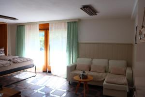 a living room with a couch and a bed at Ferienwohnung an der Seez in Mels