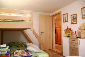 a bedroom with two bunk beds and a hallway at Ferienwohnung an der Seez in Mels