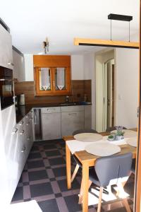 a kitchen with a table and some chairs in it at Ferienwohnung an der Seez in Mels +14 photos