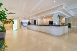 a large lobby with a counter in a building at R2 Lago Playa Park in Cala Ratjada +45 photos