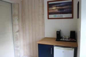 a bathroom with a wooden wall with a wooden counter top at Domaine Des Piéris - Chambres d'Hôtes in Grandcamp-Maisy