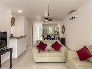 a living room with a couch and a table at Oceanblue by Andiani Travel in Playa del Carmen