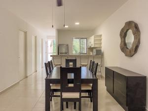 a kitchen and dining room with a table and chairs at Oceanblue by Andiani Travel in Playa del Carmen