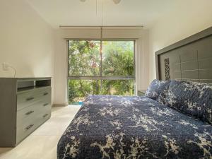 a bedroom with a bed and a large window at Oceanblue by Andiani Travel in Playa del Carmen +70 photos