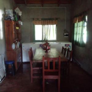 a dining room with a wooden table and chairs at Casa de montaña 