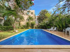 a swimming pool in the backyard of a house at Oceanblue by Andiani Travel in Playa del Carmen