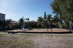 a playground with a slide in a park at Anna Maria Island Tree House Pet Friendly! in Bradenton Beach