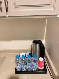 a black tray with bottles of water on a kitchen counter at Hayat Al madinah Hotel فندق حياة المدينة in Al Madinah