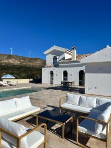 een villa met een zwembad en een huis bij Finca La Mariquitaa in Murchas
