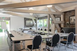 a large conference room with tables and chairs at Best Western Hotel Acadie Paris Nord Villepinte in Tremblay En France