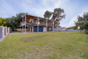 a house with a large yard in front of it at Dune View in Lancelin